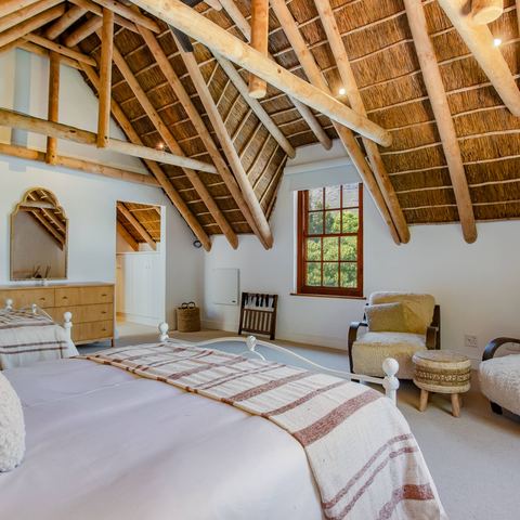 The Loft Suite under the vaulted thatched ceiling