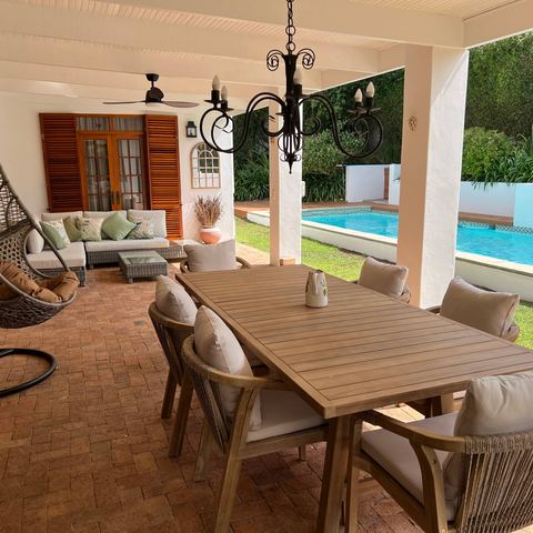Shaded dining terrace beside the pool