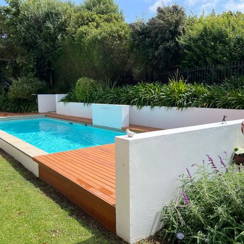 Pool deck framed by garden and lavender